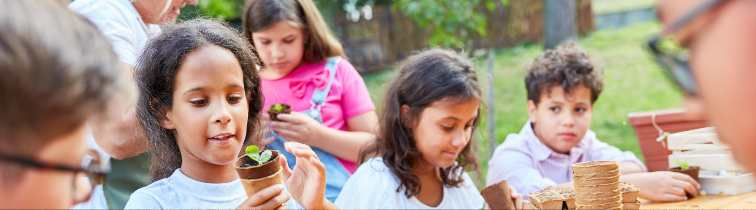 School children potting some plants