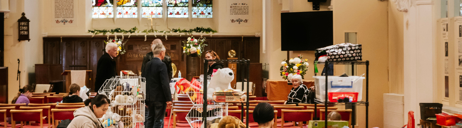 People chat and children play in a church