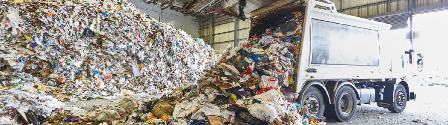 Tipping by lorry of mixed discarded packaging at recycling plant