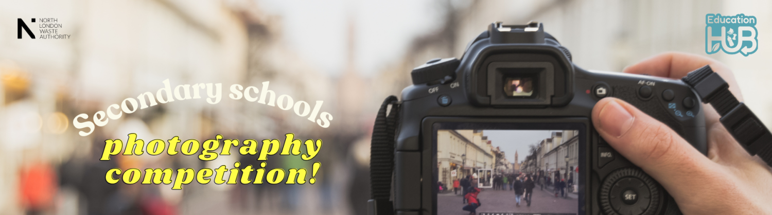 A view through the lens of a camera as someone takes a photo of a busy street. The words secondary school photography competition. 