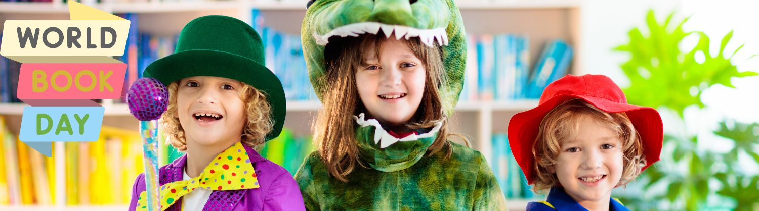 Three children dressed as book characters smiling with the the words 'Wold book day'