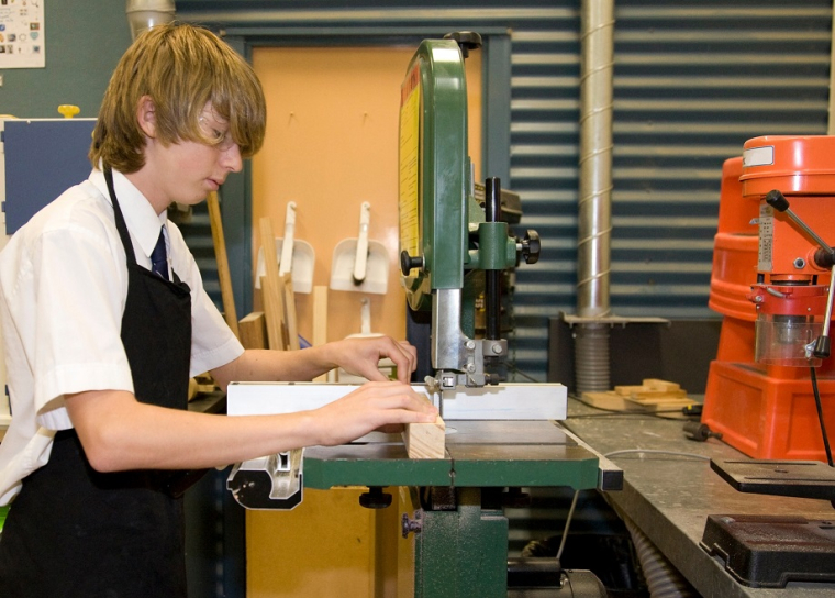 Student using a woodworking machine