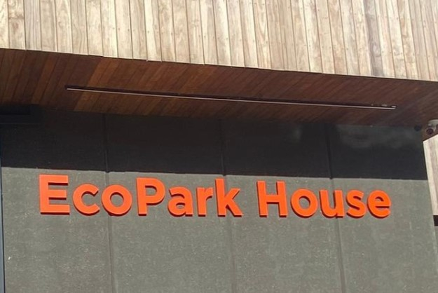 The logo of EcoPark House on the outside of a building 