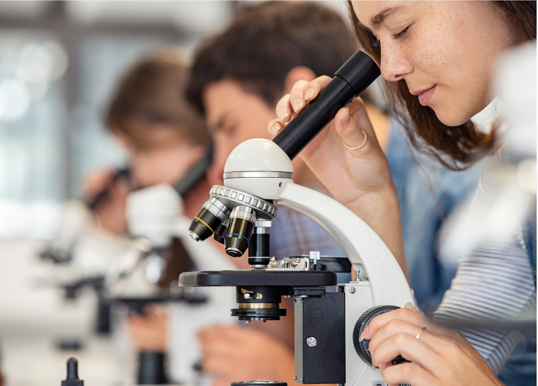 Students using a microscope in class