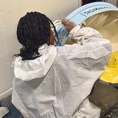 An attendee working on an art project at a previous footprint for good workshop