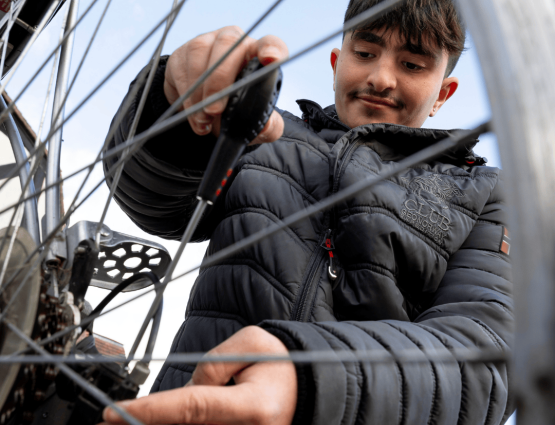 A young man working on a bike repair