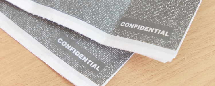 Two sheets of paper with the word 'confidential' written across the bottom