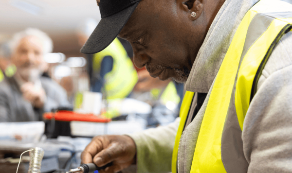 Man working on fixing an electrical item at a repair event