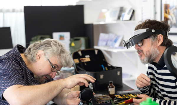 Two people fixing an electrical