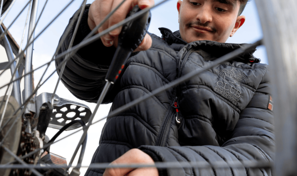 A young man working on a bike repair